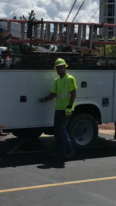 Warren standing next to his work truck